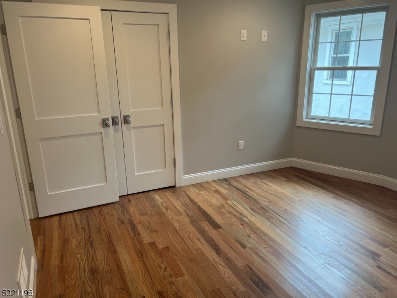 33 Morris Avenue Summit, NJ 07901 - Photo 17 of 28 an empty room with wooden floor closet and windows