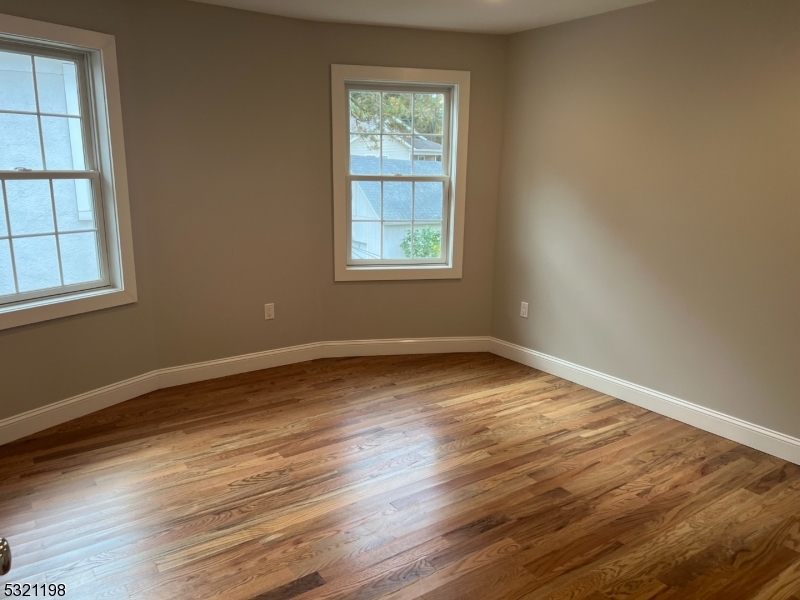 33 Morris Avenue Summit, NJ 07901 - Photo 18 of 28 a view of an empty room with wooden floor and a window