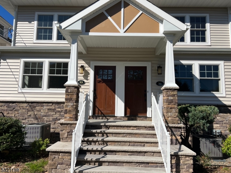 33 Morris Avenue Summit, NJ 07901 - Photo 3 of 28 a front view of a house with a garden