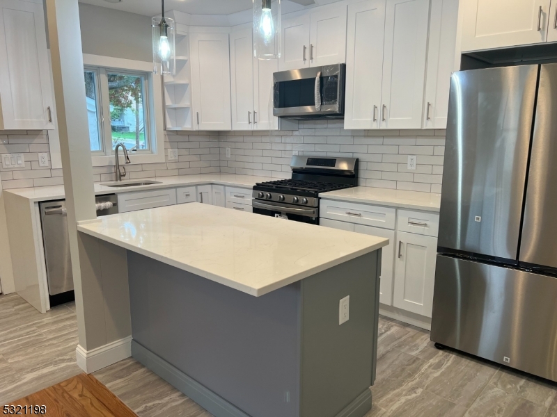 33 Morris Avenue Summit, NJ 07901 - Photo 4 of 28 a kitchen with stainless steel appliances a refrigerator a sink a stove a microwave a sink and cabinets