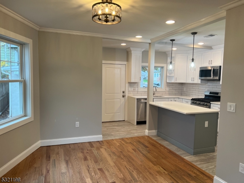 33 Morris Avenue Summit, NJ 07901 - Photo 7 of 28 a kitchen with a sink cabinets stainless steel appliances and a window
