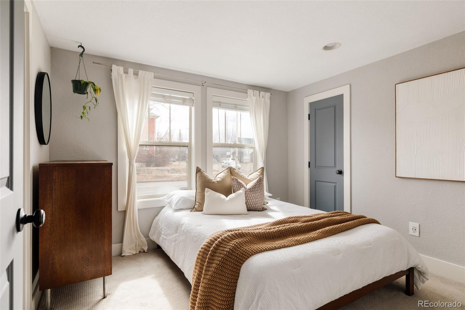 3100 North High Street Denver, CO 80205 - Photo 11 of 28 a bedroom with a large bed and a window