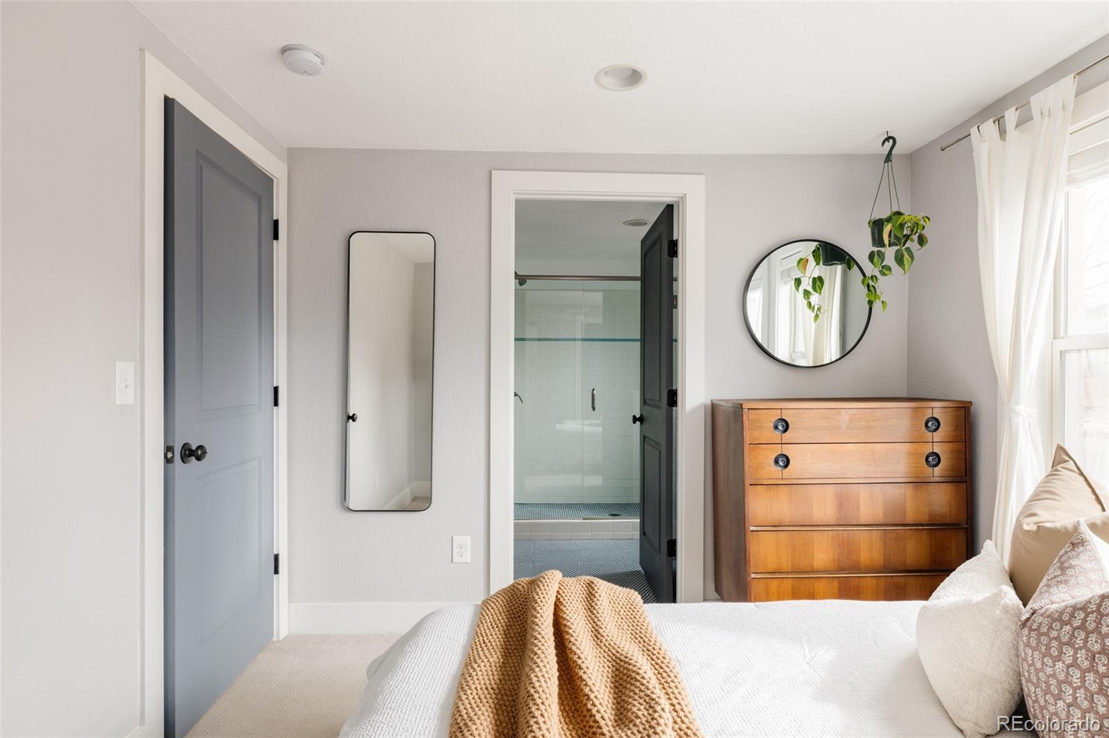 3100 North High Street Denver, CO 80205 - Photo 12 of 28 a bedroom with a bed and a window in it