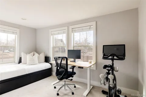a bedroom with a workspace