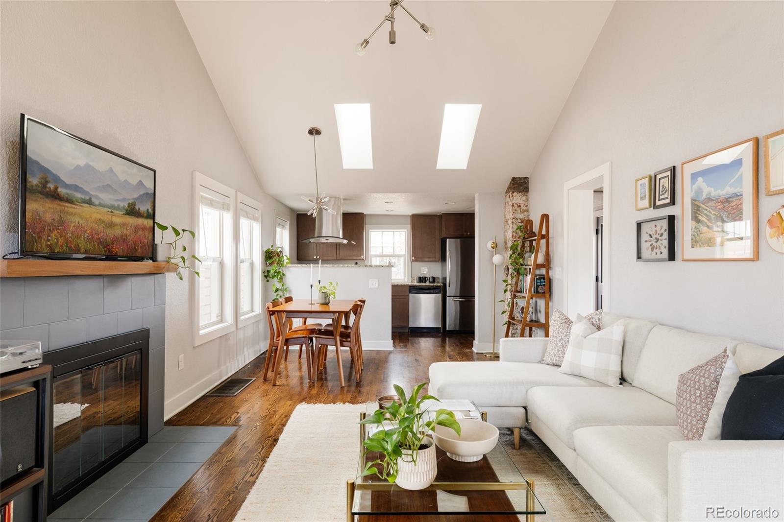 3100 North High Street Denver, CO 80205 - Photo 2 of 28 a living room with furniture fireplace and dining room