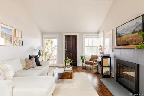a living room with furniture large window and a fireplace