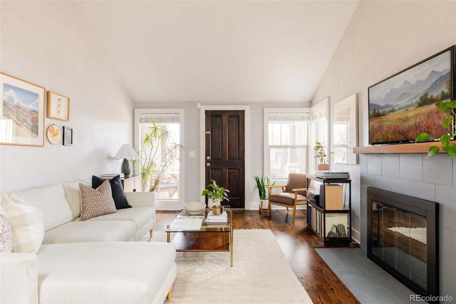 3100 North High Street Denver, CO 80205 - Photo 4 of 28 a living room with furniture large window and a fireplace