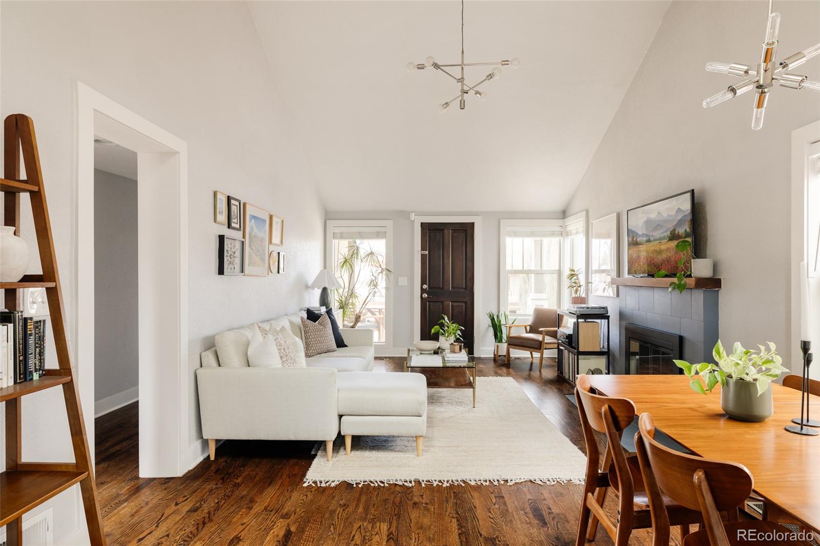 3100 North High Street Denver, CO 80205 - Photo 5 of 28 a living room with furniture and a flat screen tv