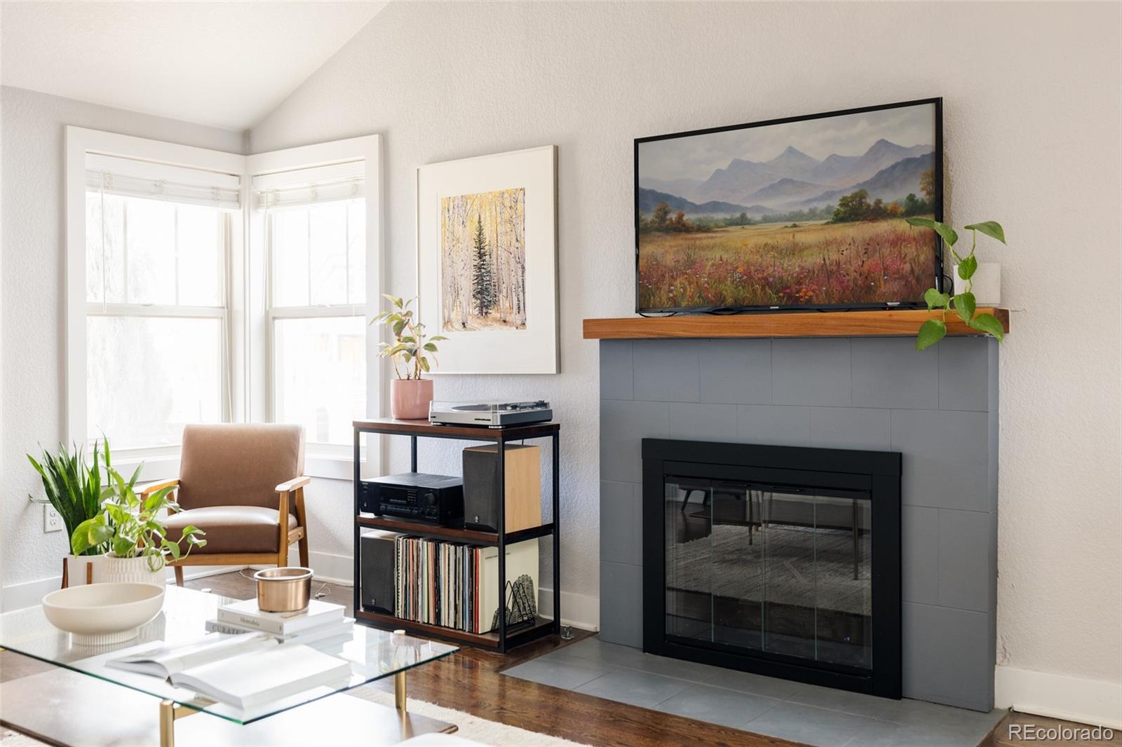 3100 North High Street Denver, CO 80205 - Photo 6 of 28 a living room with furniture a flat screen tv and a fireplace