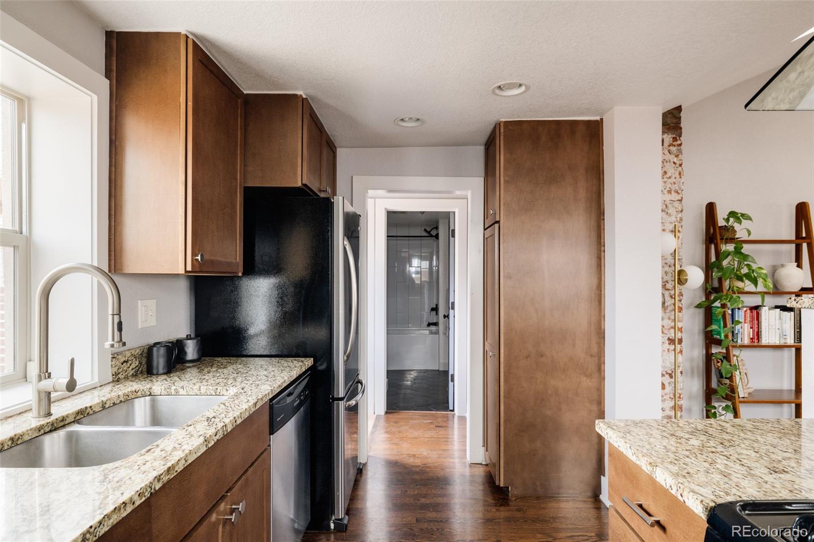 3100 North High Street Denver, CO 80205 - Photo 10 of 28 a kitchen with stainless steel appliances granite countertop a sink stove and refrigerator