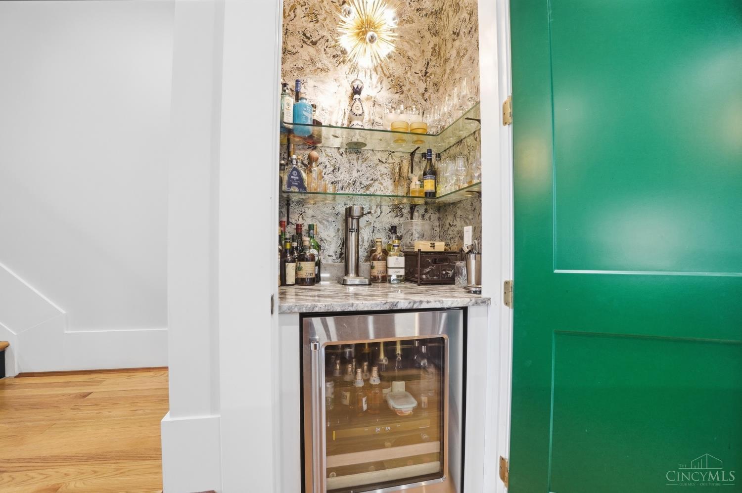 1338 Spring Street Cincinnati, OH 45202 - Photo 12 of 46 The first floor boasts a dry bar with a beverage fridge cleverly tucked behind a door.