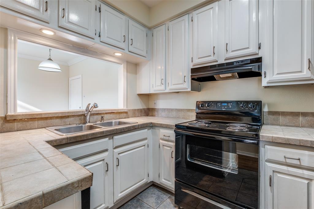 4034 Rawlins Street, Unit 102 Dallas, TX 75219 - Photo 12 of 24 a kitchen with cabinets appliances and a sink