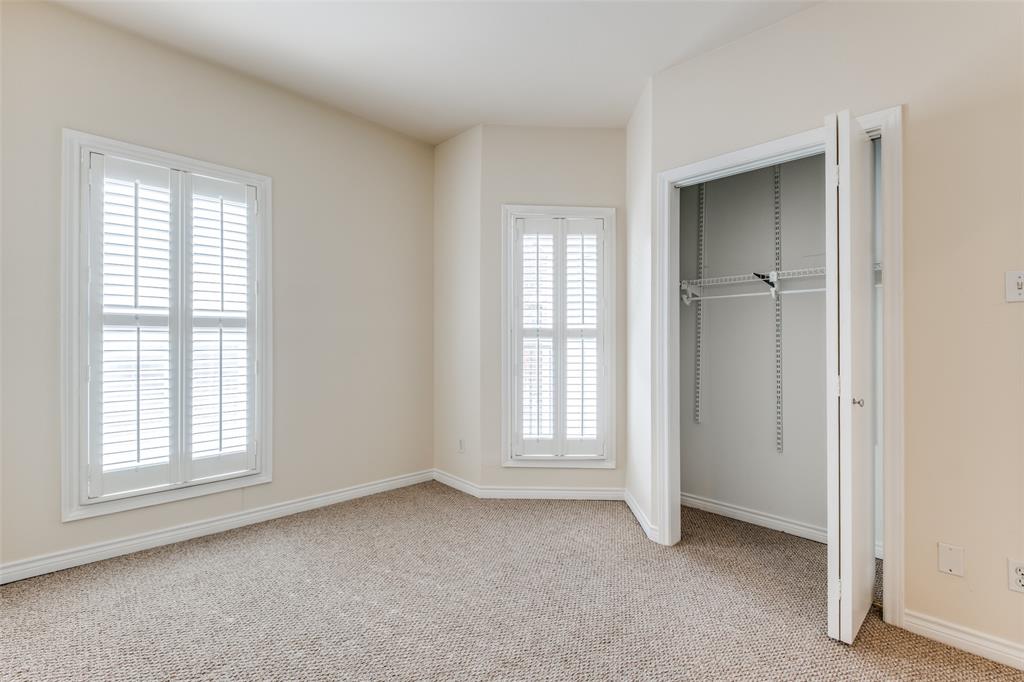 4034 Rawlins Street, Unit 102 Dallas, TX 75219 - Photo 16 of 24 an empty room with windows and closet