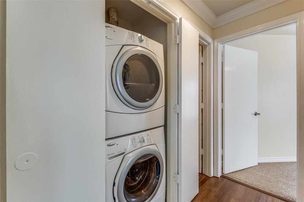 4034 Rawlins Street, Unit 102 Dallas, TX 75219 - Photo 17 of 24 a view of a hallway with washer and dryer
