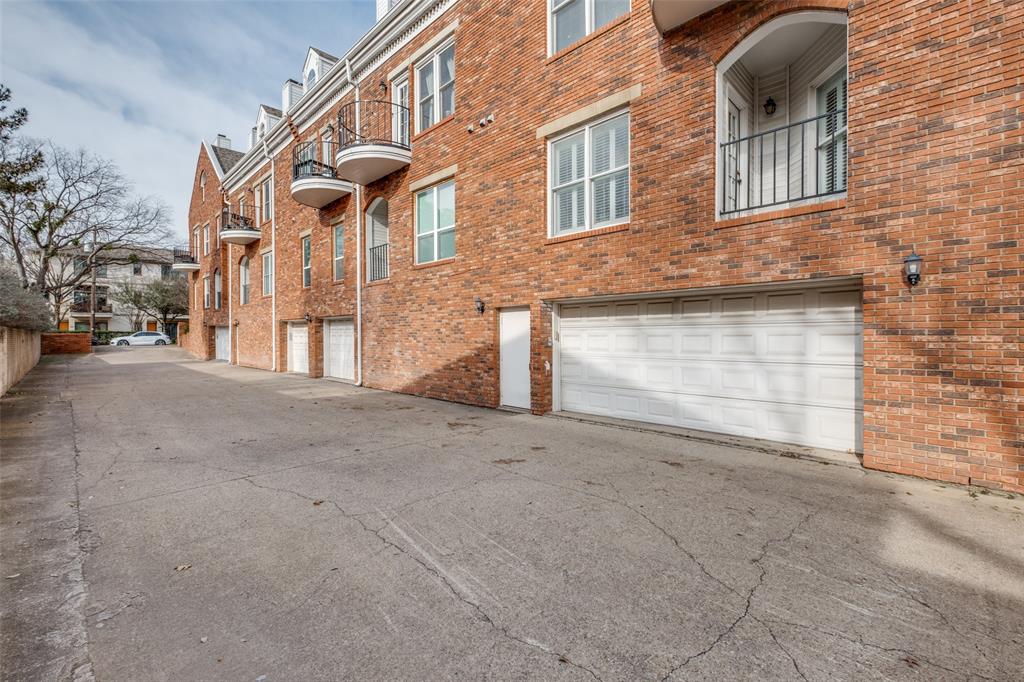 4034 Rawlins Street, Unit 102 Dallas, TX 75219 - Photo 3 of 24 front view of a brick house with a large windows