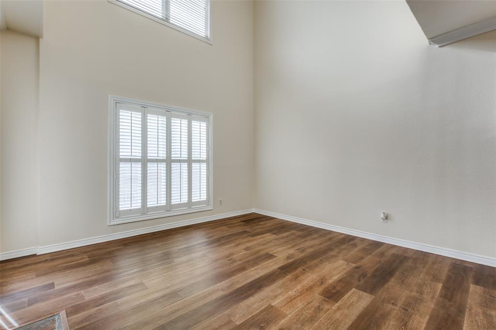 4034 Rawlins Street, Unit 102 Dallas, TX 75219 - Photo 6 of 24 an empty room with wooden floor and windows