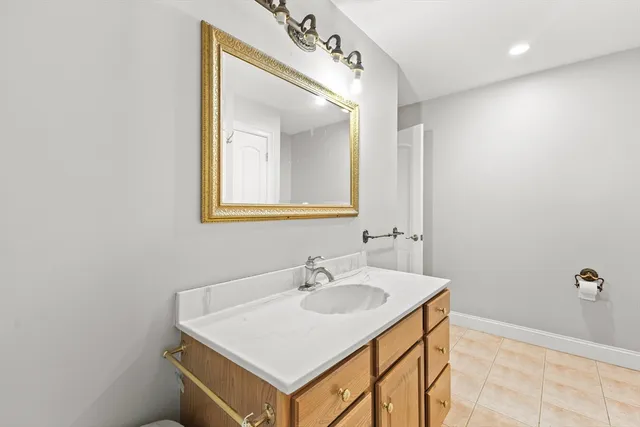 a bathroom with a sink a mirror and vanity