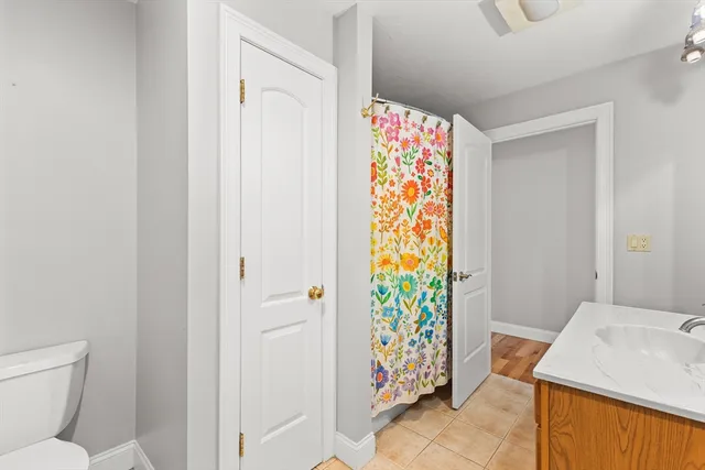 a bathroom with a shower curtain and a sink