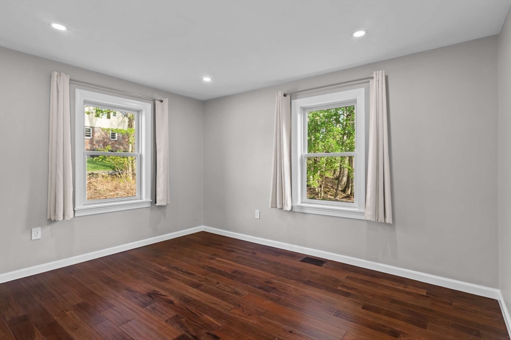 7 Darrow Street Worcester, MA 01606 - Photo 20 of 42 a view of an empty room with wooden floor and a window