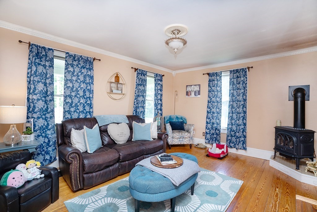 215 Market Street Amesbury, MA 01913 - Photo 15 of 41 a living room with furniture and a fireplace