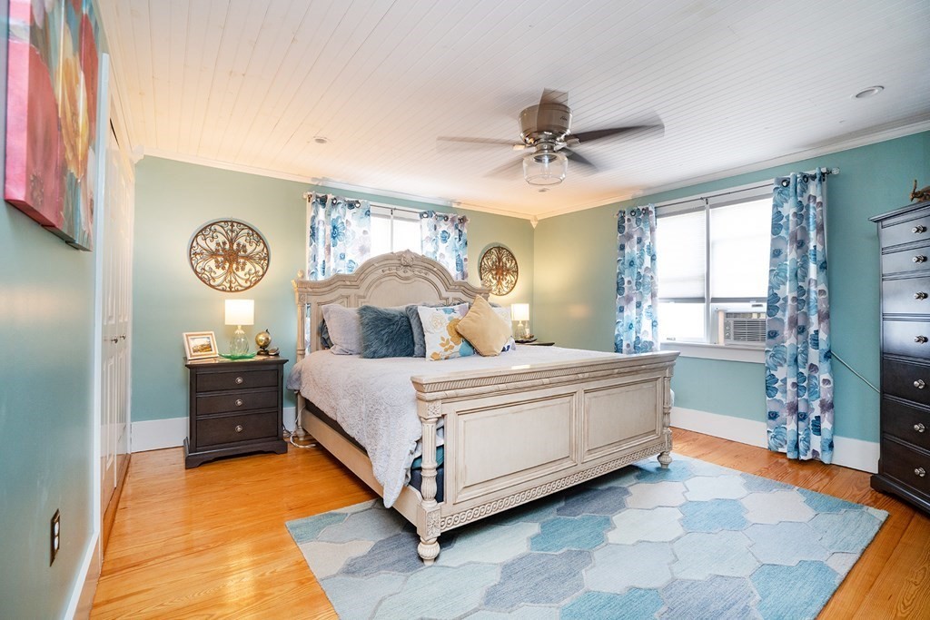 215 Market Street Amesbury, MA 01913 - Photo 21 of 41 a bed room with a bed and a chandelier