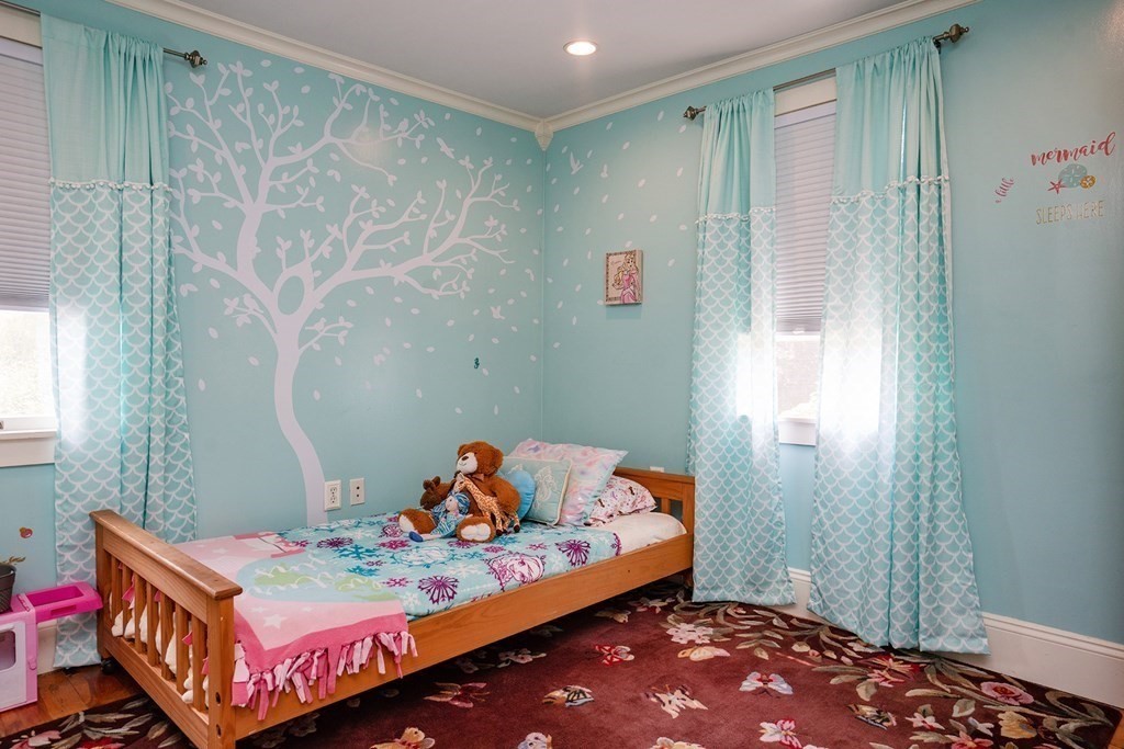 215 Market Street Amesbury, MA 01913 - Photo 32 of 41 a bedroom with a bed and a table in it