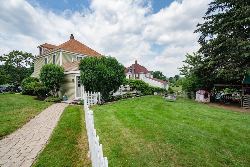 215 Market Street Amesbury, MA 01913 - Photo 6 of 41 a front view of a house with a yard