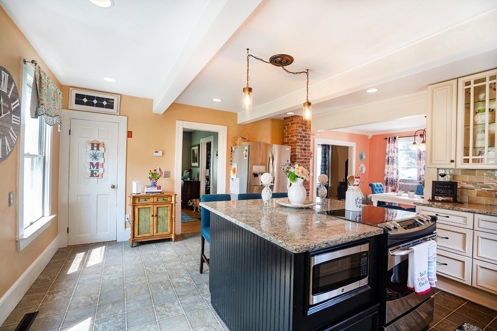 215 Market Street Amesbury, MA 01913 - Photo 8 of 41 a open kitchen with stainless steel appliances granite countertop a stove and refrigerator