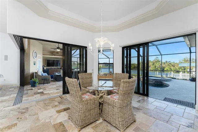 a living room with furniture a flat screen tv and a table