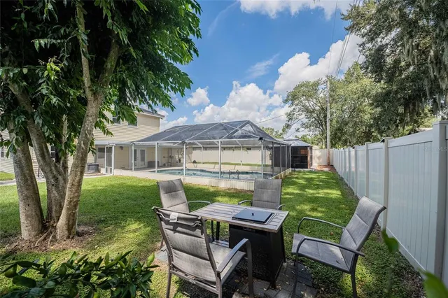 a view of a house with backyard sitting area and garden