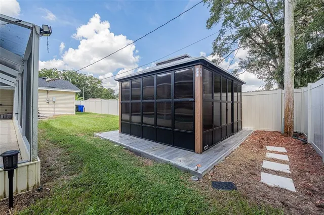 a view of a backyard with a large tree