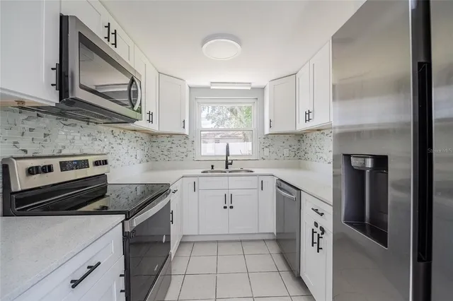 a kitchen with a sink stove and cabinets