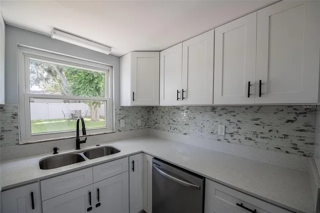a kitchen with a sink and cabinets