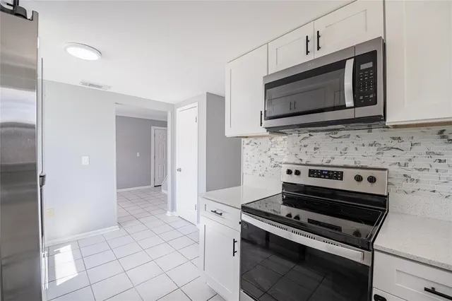 a kitchen with a stove and a microwave