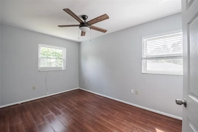 wooden floor in an empty room with a window