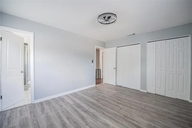 a view of a room with wooden floor