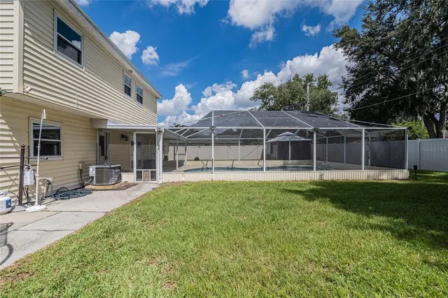 a view of a house with a backyard and a patio