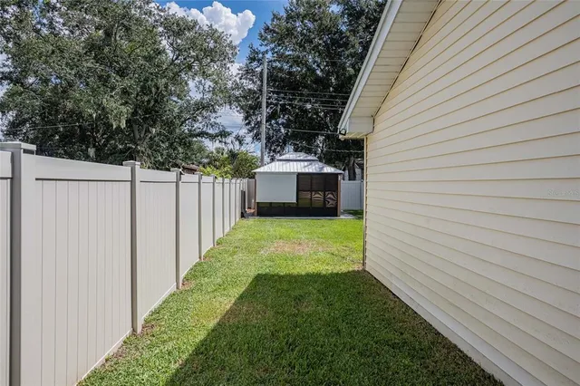 a view of a backyard with white house