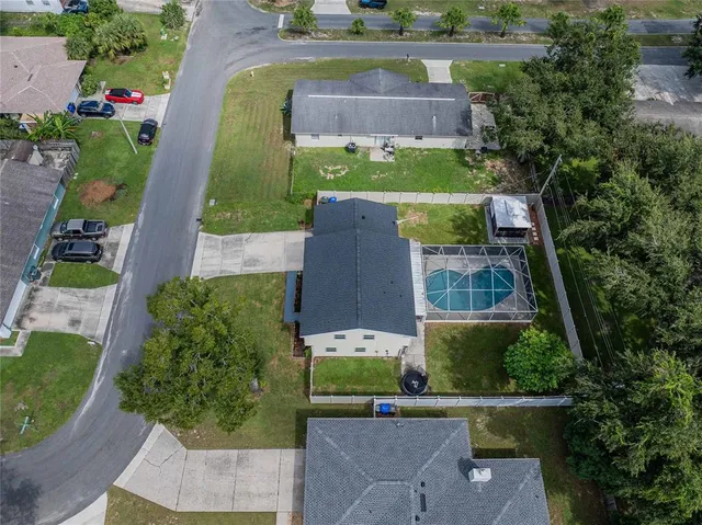 an aerial view of a house with a garden and a yard