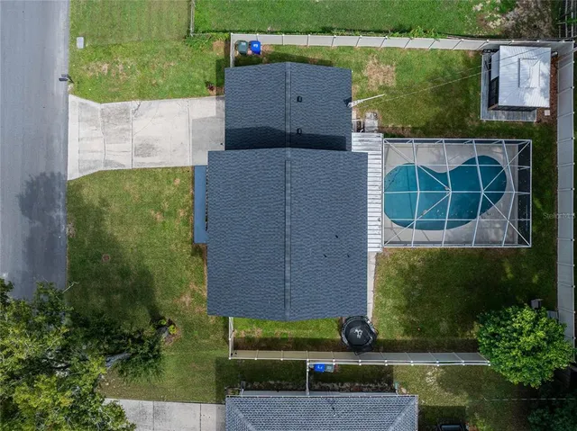 an aerial view of a house with a yard and potted plants