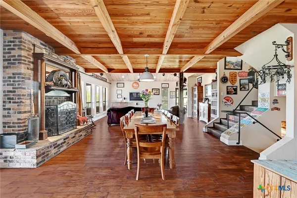 a dining room with furniture entryway and wooden floor