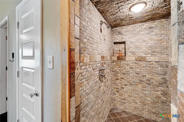 a bathroom with a shower and a mirror
