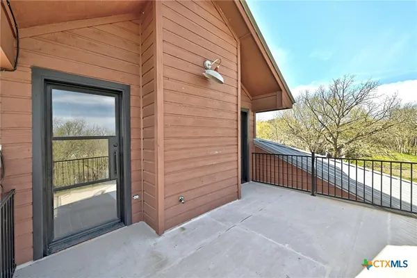a view of a balcony with wooden floor