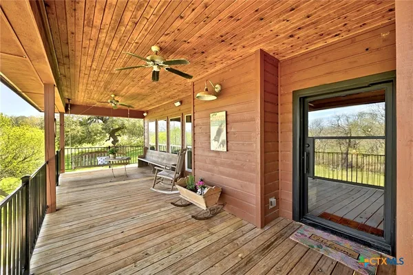 a view of a balcony with wooden floor