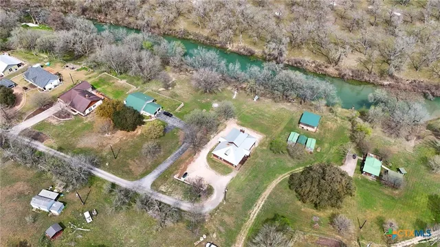 an aerial view of a house with a yard