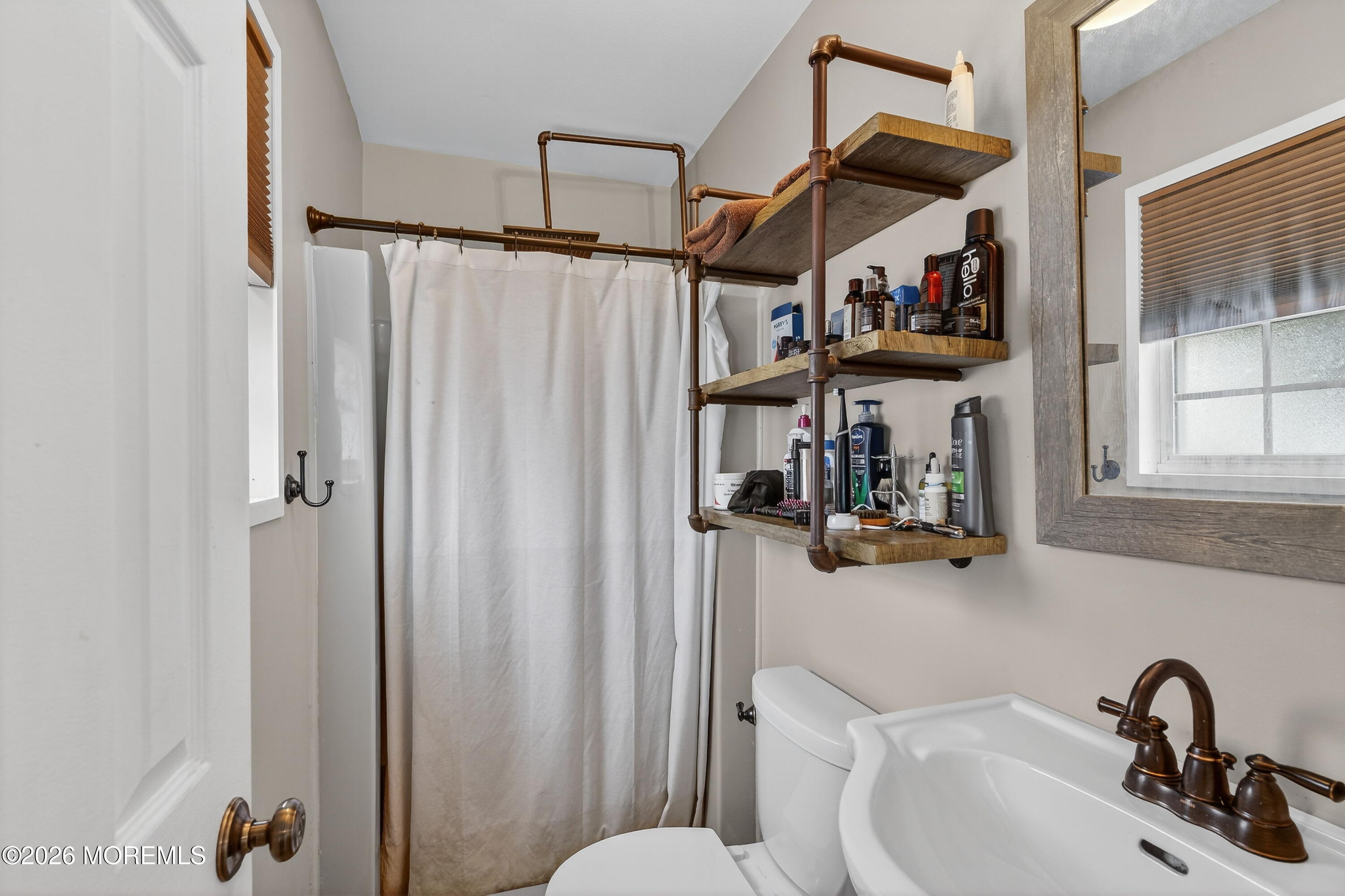 1660 Joffre Road Forked River, NJ 08731 - Photo 24 of 35 a bathroom with a sink and a mirror
