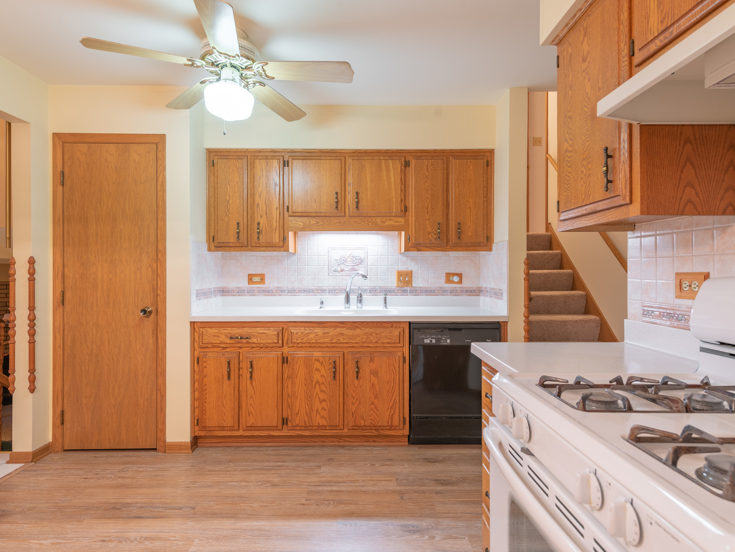 17841 Maine Court Orland Park, IL 60467 - Photo 16 of 29 a kitchen with stainless steel appliances a stove a sink dishwasher and a refrigerator with wooden floor