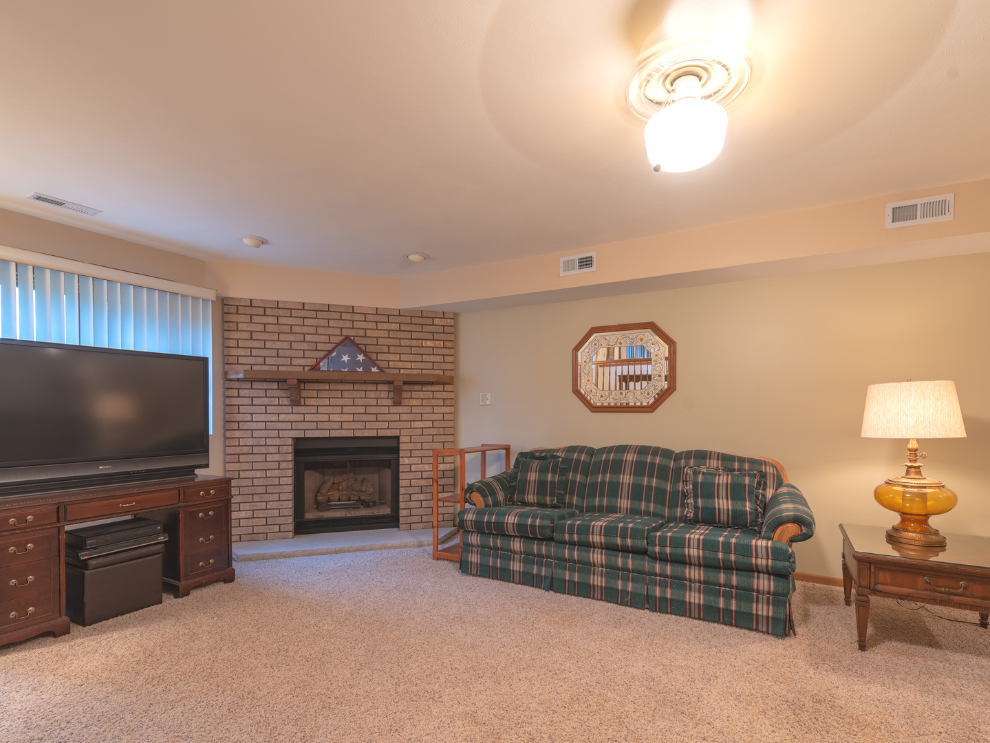 17841 Maine Court Orland Park, IL 60467 - Photo 17 of 29 a living room with a flat screen tv and a fireplace