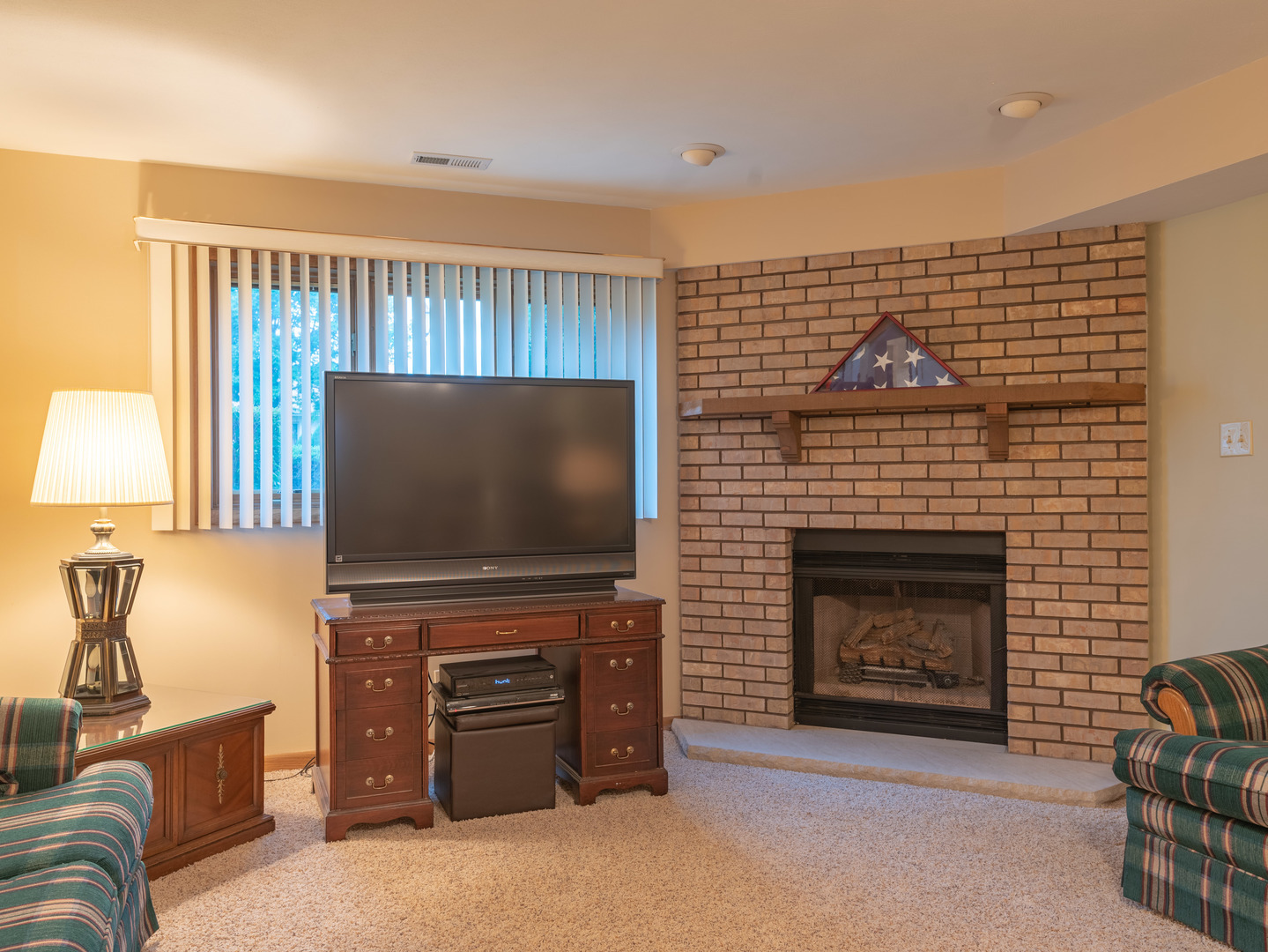 17841 Maine Court Orland Park, IL 60467 - Photo 18 of 29 a living room with furniture a flat screen tv and a fireplace