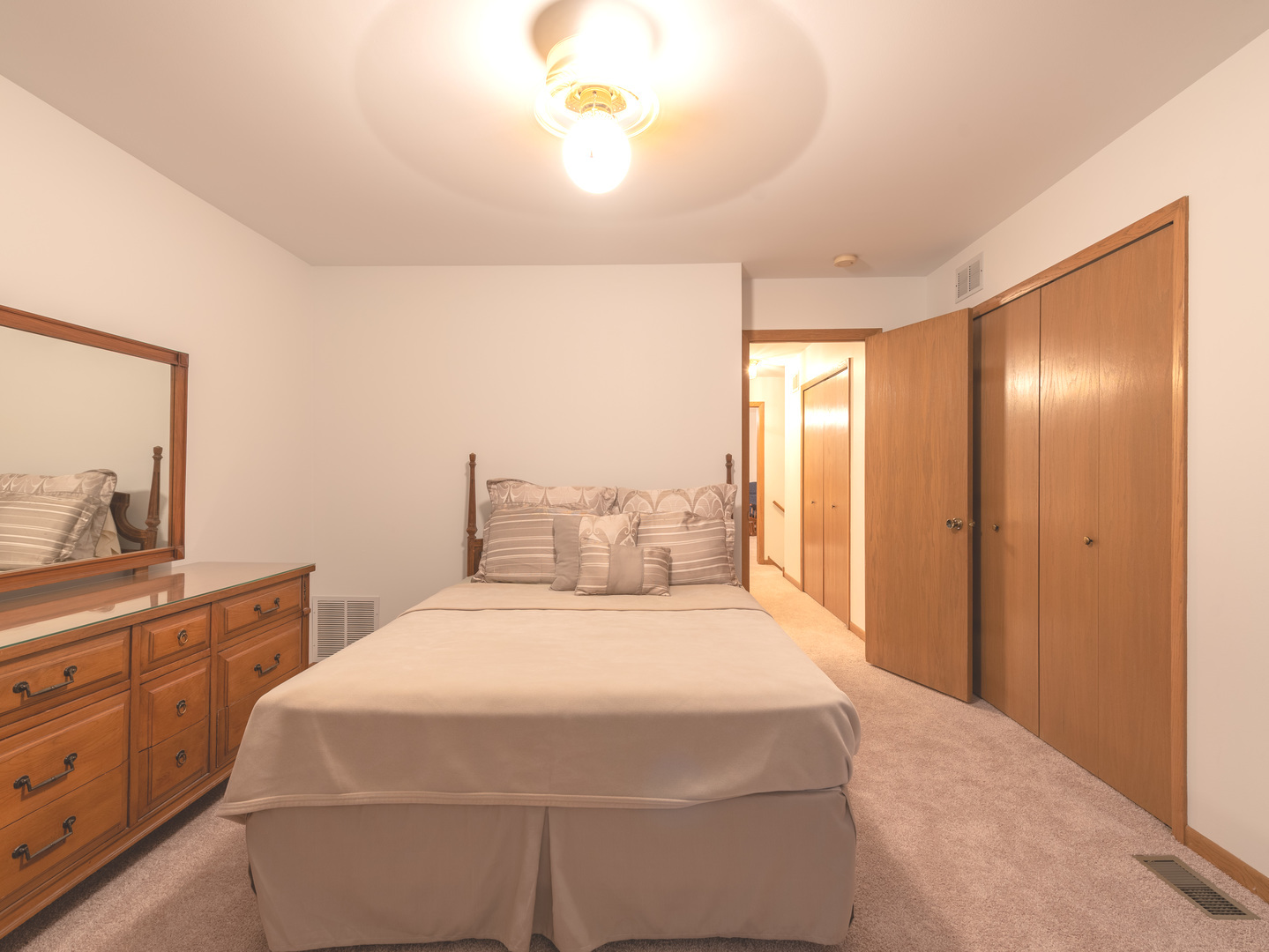 17841 Maine Court Orland Park, IL 60467 - Photo 28 of 29 a bedroom with a large bed and a chandelier